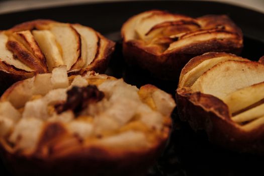 Small homemade apple pies freshly baked each in its mold