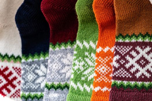 traditional Latvian knitted woolen mittens and socks, precious artefacts, variety of colors, different in Latvian regions, they are present in festivities and family occasions