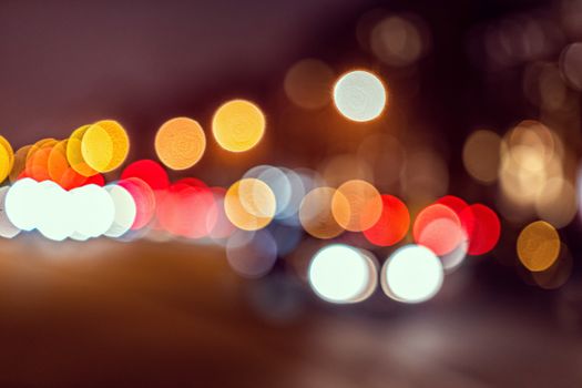 Blurred defocused colorful lights of traffic in the city, the night city with boken
