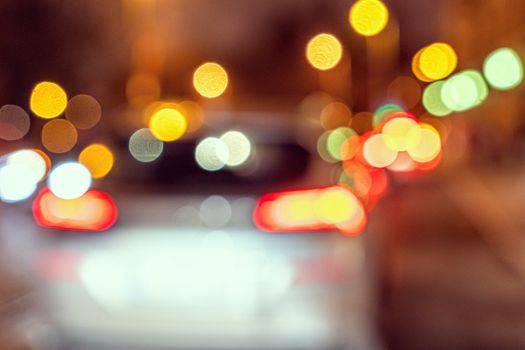 Blurred defocused colorful lights of traffic in the city, the night city with boken