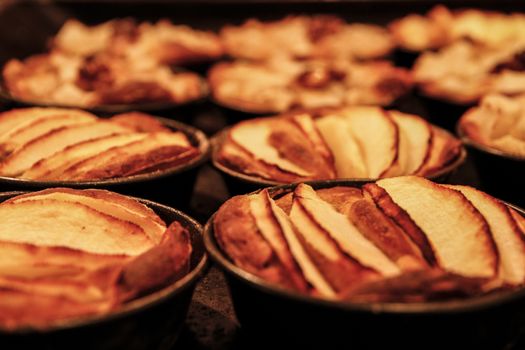 Small homemade apple pies freshly baked each in its mold