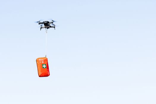 drone delivers a first aid kit with coronavirus medication, concept for delivery of COVID-19 virus medication using modern technology