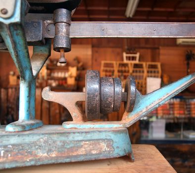 Partial view of an old balance scale in a traditional store
