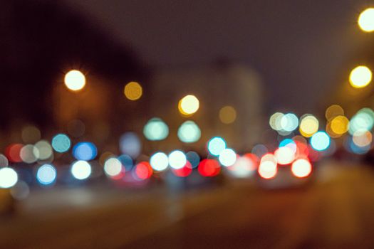 Blurred defocused colorful lights of traffic in the city, the night city with boken