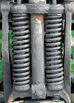 Vintage coil spring suspension on an old three wheel truck
