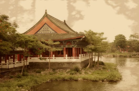 Vintage photograph of old Chinese temple by the lakeside

