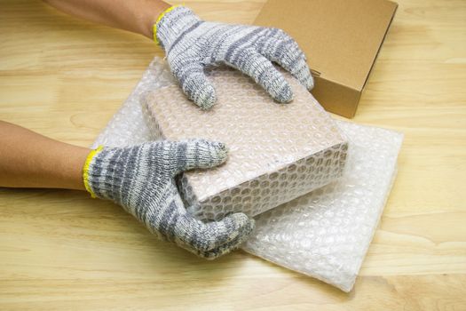 hand of man hold bubble wrap, for protection parcel product cracked or insurance During transit  