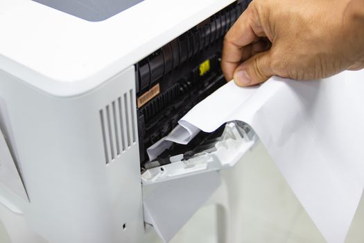 Technicians Removing Paper Stuck, Paper Jam In Printer At Office
