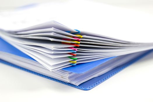 close up of Stack of papers files piles of unfinished documents achieves with paper clips 
