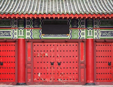 A large gate leading to a traditional Chinese temple
