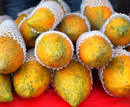 Organically grown papayas are sold at an outdoor market
