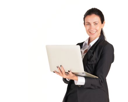 A business woman in a black suit with a smile and typing on a computer notebook. Portrait on white background with studio light.