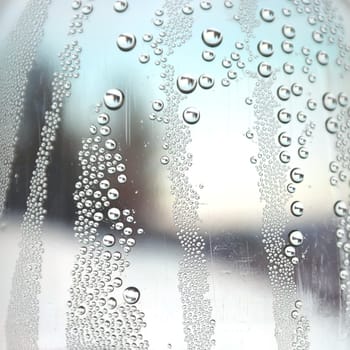 Abstract background. Drops of water on the crooked glass, shallow dof