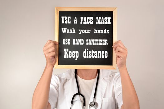 Doctor giving recommendations to avoid becoming infected with covid-19 use a face mask,wash your hands,use hand sanitizer and keep distance
