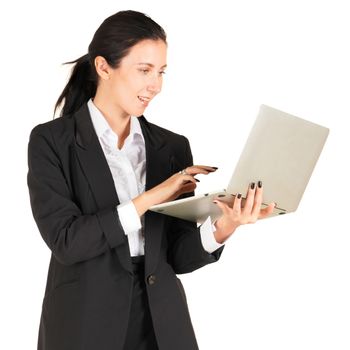 A business woman in a black suit with a smile and typing on a computer notebook. Portrait on white background with studio light.