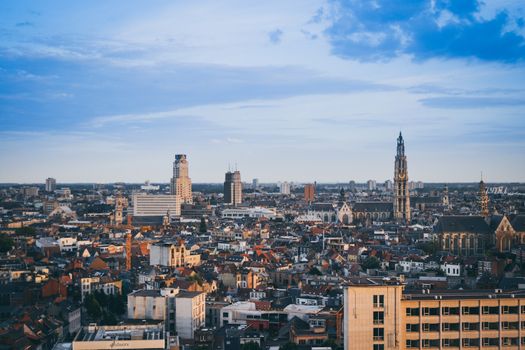 Antwerp, Belgium, June 2011: city skyline and cityscape with cathedral and boerentoren (KBC tower) on a blue sky.