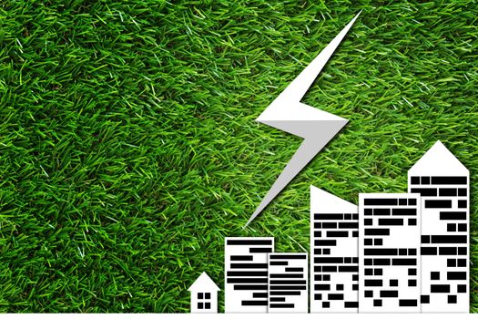 Green energy concept, white paper cut city and power symbol on grass background, nature and ecology
