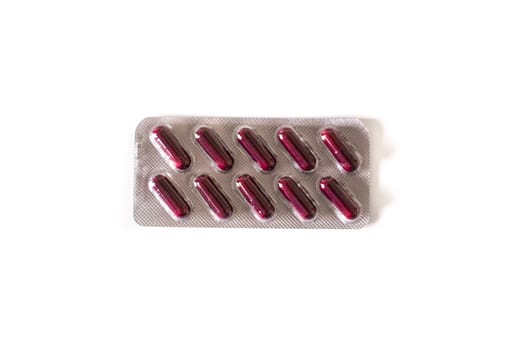 Red medical pills isolated on white background