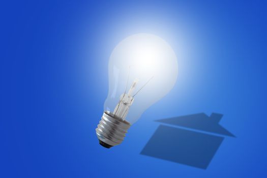 Energy concept, house shadow and light bulb on blue background, nature and ecology