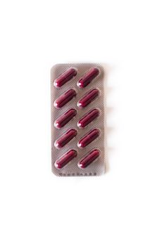 Red medical pills isolated on white background