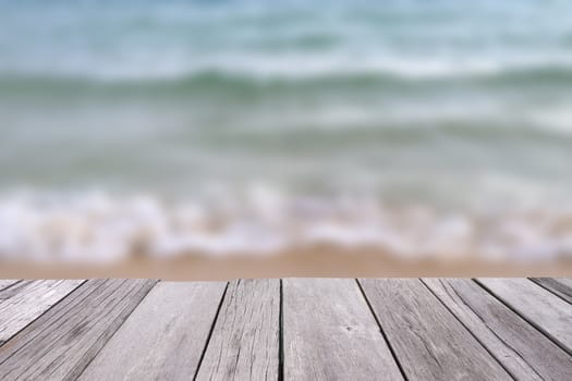 Wooden old plank with blurred sea background.