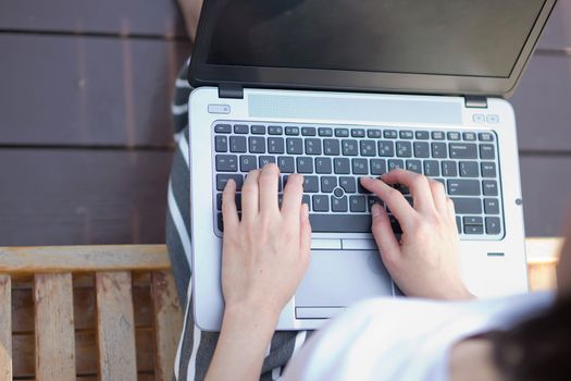 Young Caucasian woman using Laptop on nature