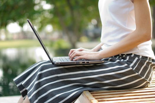 Young Caucasian woman using Laptop on nature