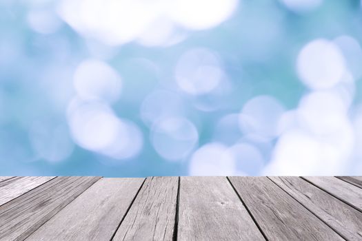 Old wooden floor with blue blurred background.