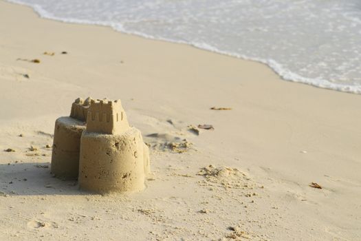 Sand castle on the beach. Children build sand castles on the beach.
