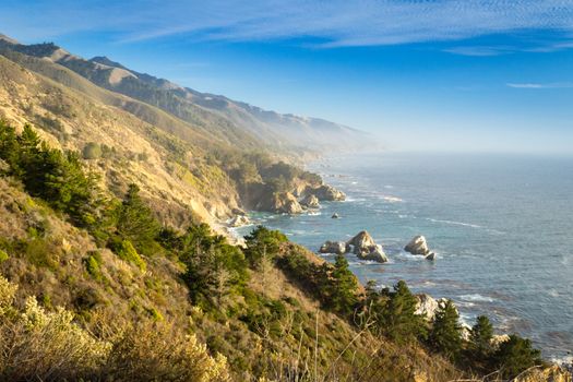 Coastal view of Big Sur landscape and scenery, with pacific ocean and rocks on the coastline during sunset.California, USA. Travel and tourism