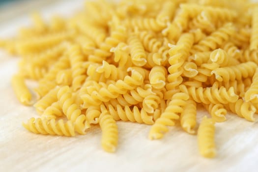 Fusilli on the wooden table. Fusilli is a type of spaghetti.