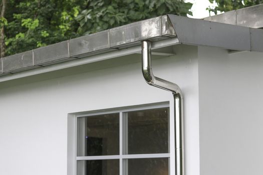 Rain gutters and pipes for drainage of rainwater from the roof.