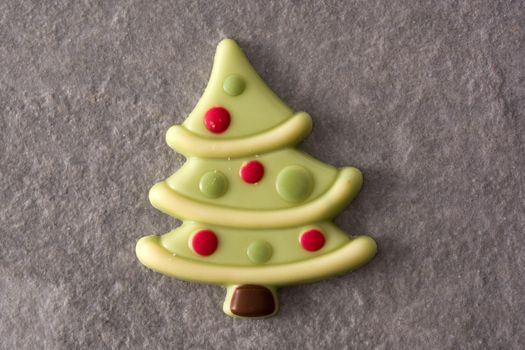 Christmas tree chocolate bonbon on gray stone background