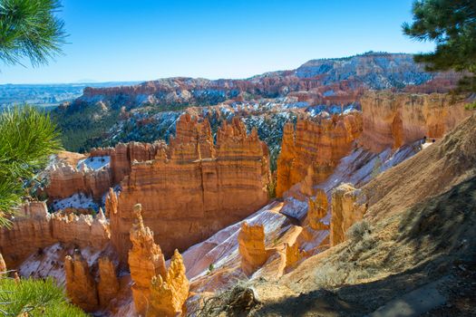 Snow topped Bryce canyon with hoodoos on a sunny day during golden hour, national park, Utah, USA