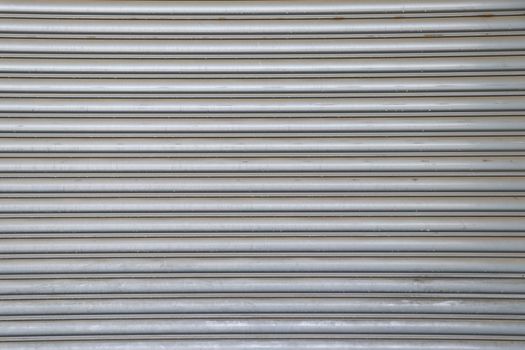 Rolling steel door background. Steel rolling door surface.