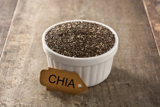 Chia seeds in bowl on wooden table