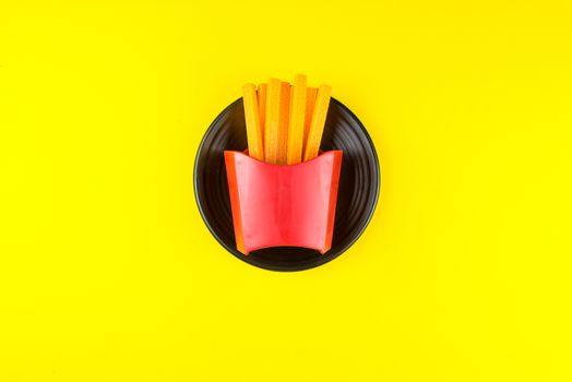French fries toy in black bowl.