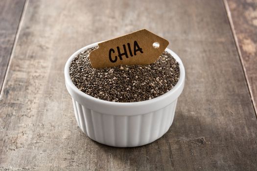 Chia seeds in bowl on wooden table