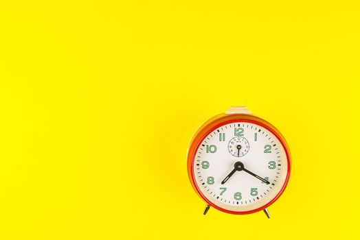 Red alarm clock isolated on yellow background, Time concept, Rush hour concept, Copy space image for your text, Flat lay