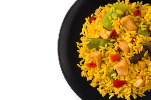 Fried rice with chicken and vegetables on black plate isolated on white background