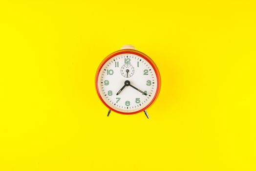 Red alarm clock isolated on yellow background, Time concept, Rush hour concept, Copy space image for your text, Flat lay