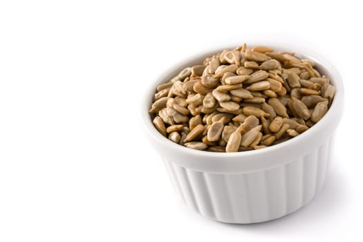 Sunflower seeds in bowl isolated on white background