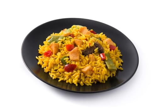 Fried rice with chicken and vegetables on black plate isolated on white background