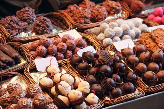 Sweet chocolate candy market .Confectionery at Boqueria market place in Barcelona, Spain. Assorted chocolate candy shop with variation of candies