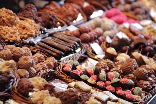 Sweet chocolate candy market .Confectionery at Boqueria market place in Barcelona, Spain. Assorted chocolate candy shop with variation of candies