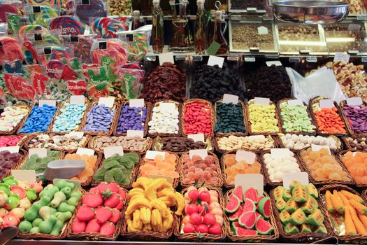 Assorted colorful jelly candies at the candy shop market stall color background
