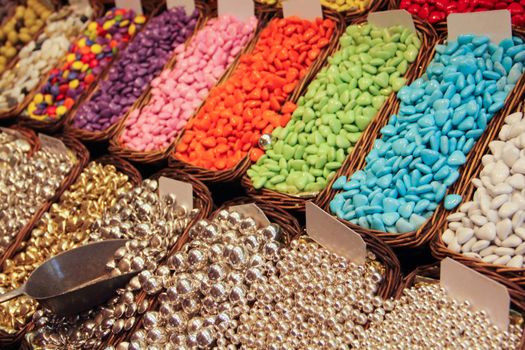 Assorted colorful jelly candies at the candy shop market stall color background