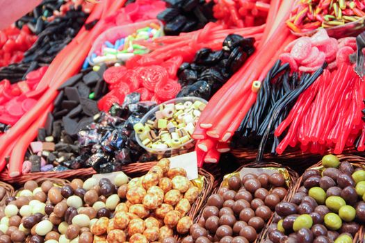 Assorted colorful jelly candies at the candy shop market stall color background