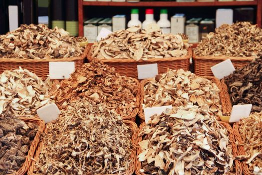Abundance of dried mushrooms at market stall background