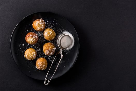 Carnival fritters or buñuelos de viento for holy week on black background